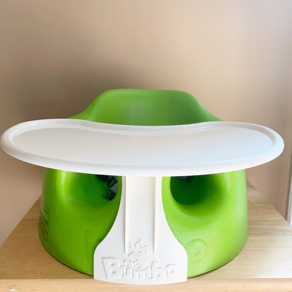 green bumbo with tray